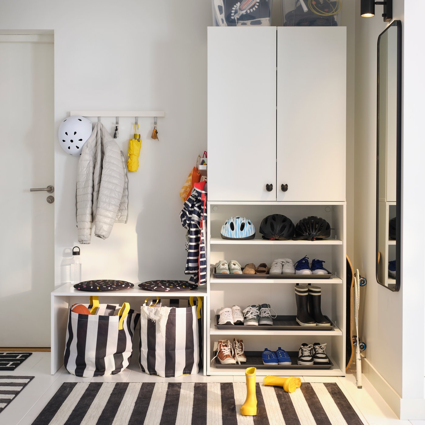 A black/white/stripe ELSYSTEM rug, low pile in the hallway