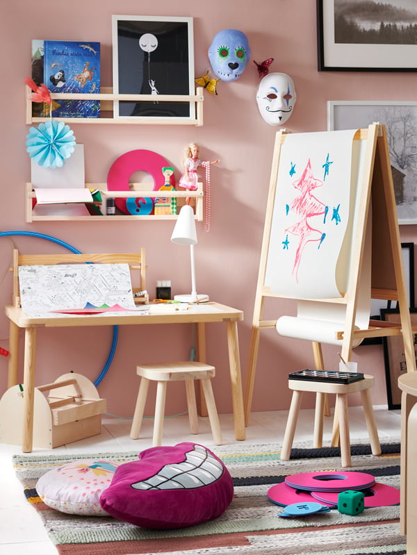 FLISAT Children's stools are placed around a child's playroom, where there are drawings on the FLISAT children's table and a notice board.