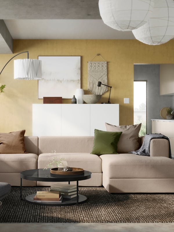 A grey/beige JÄTTEBO 4-seat modular sofa with chaise longue in the living room.