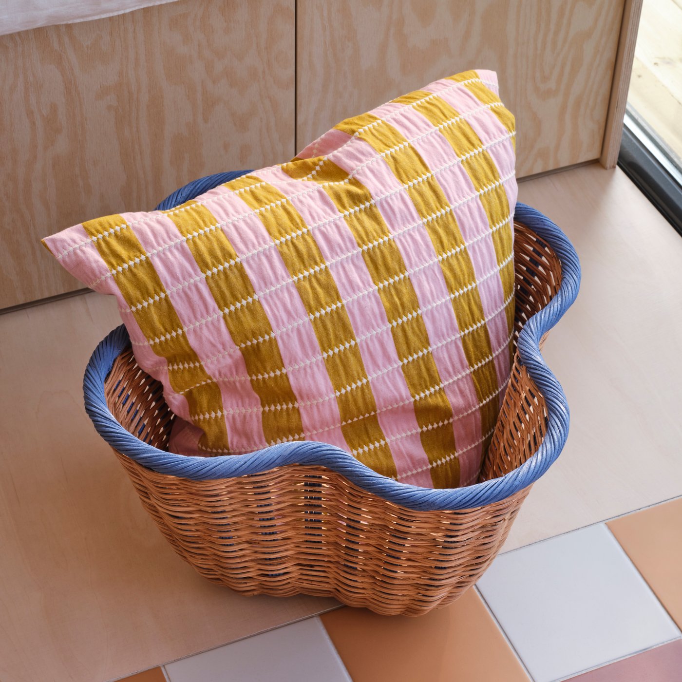 A pink/beige OMMJÄNGE cushion cover