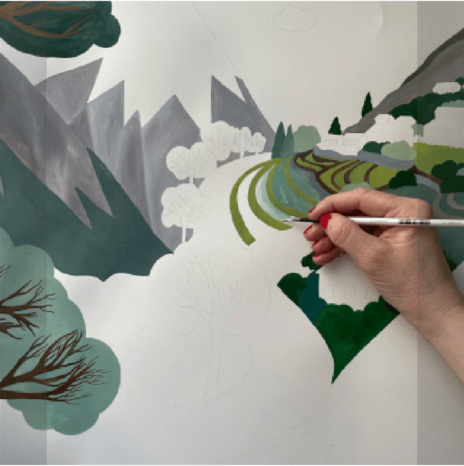 ALPTALL designer Malin Gyllensvaan hand-painting a Himalayan landscape for ALPTALL products in the children’s collection.