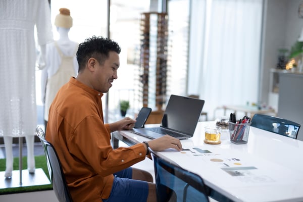 A man sits in front of a computer