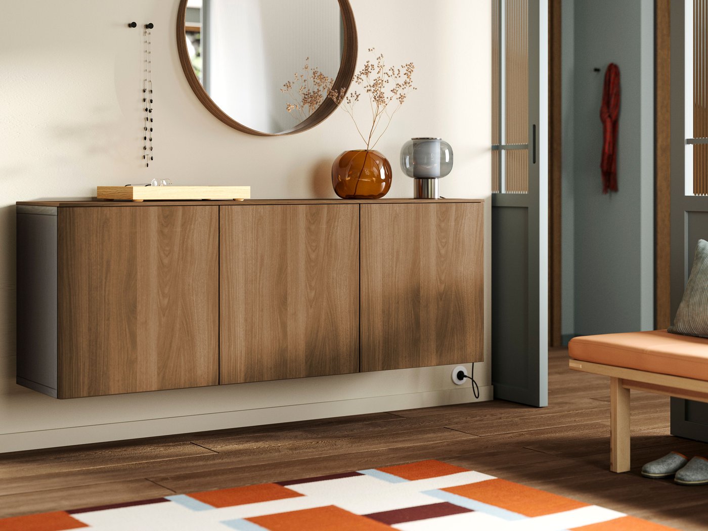 A black-brown Lappviken/brown walnut effect BESTÅ wall-mounted cabinet combination in the living room.