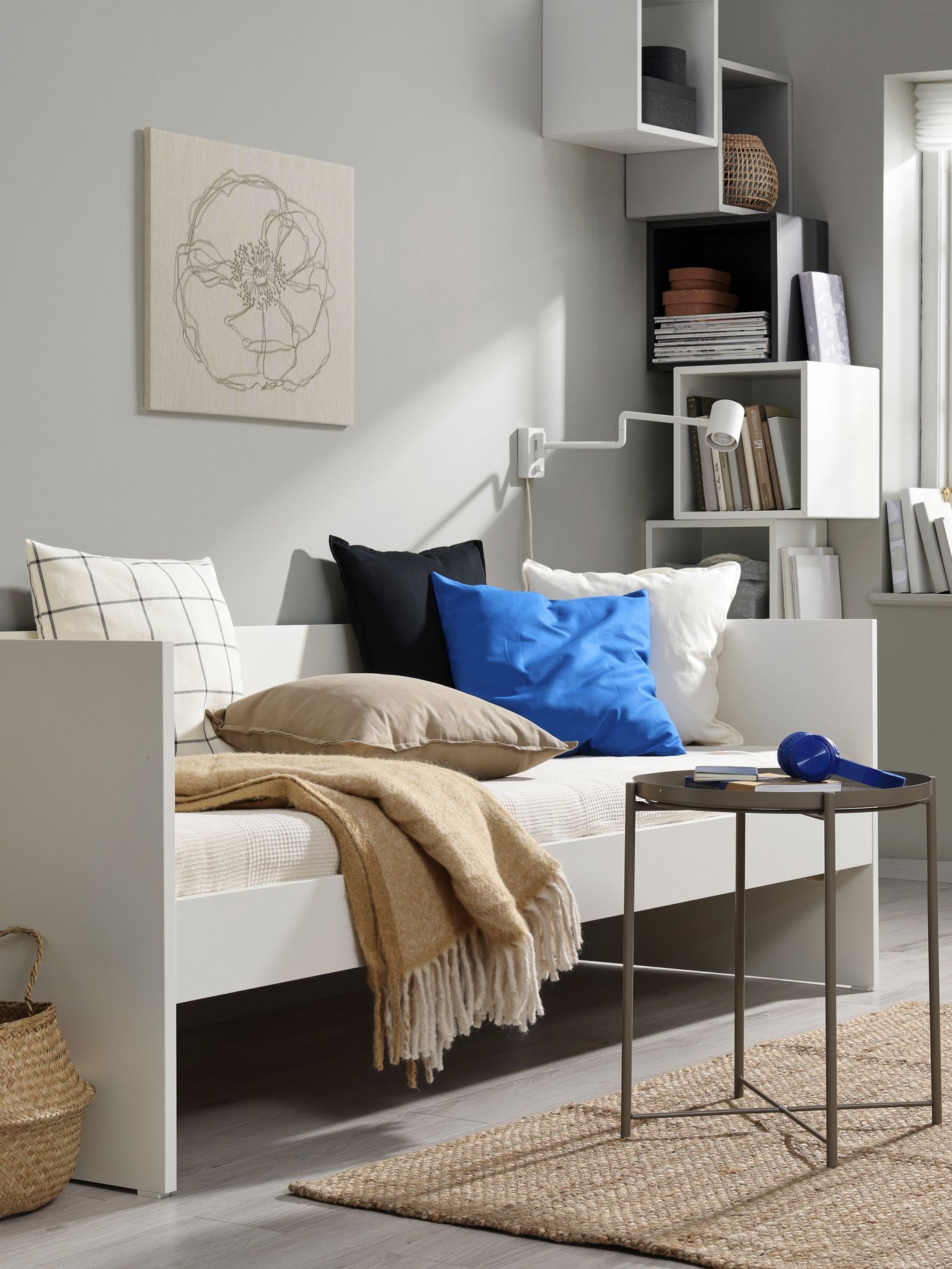 A white VIHALS day-bed frame in the living room