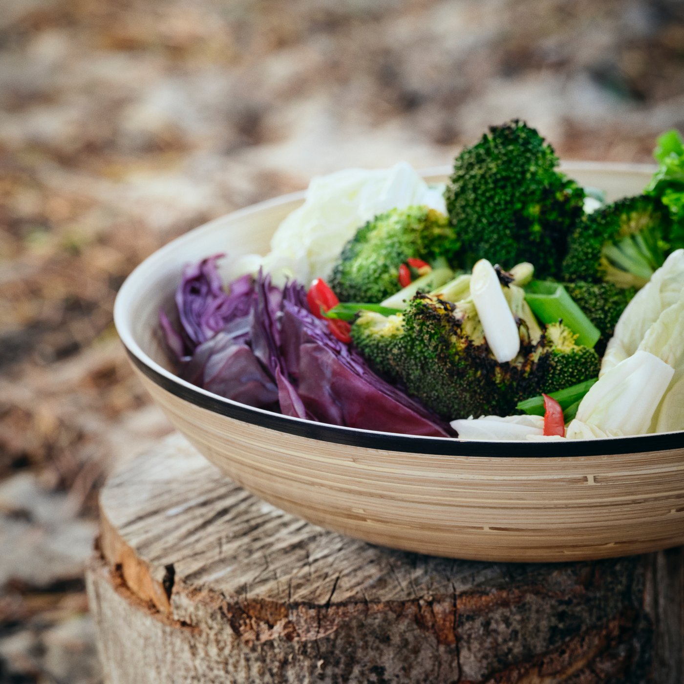 A SOLUPPGÅNG serving bowl made of bamboo is filled with fresh and colorful vegetables.