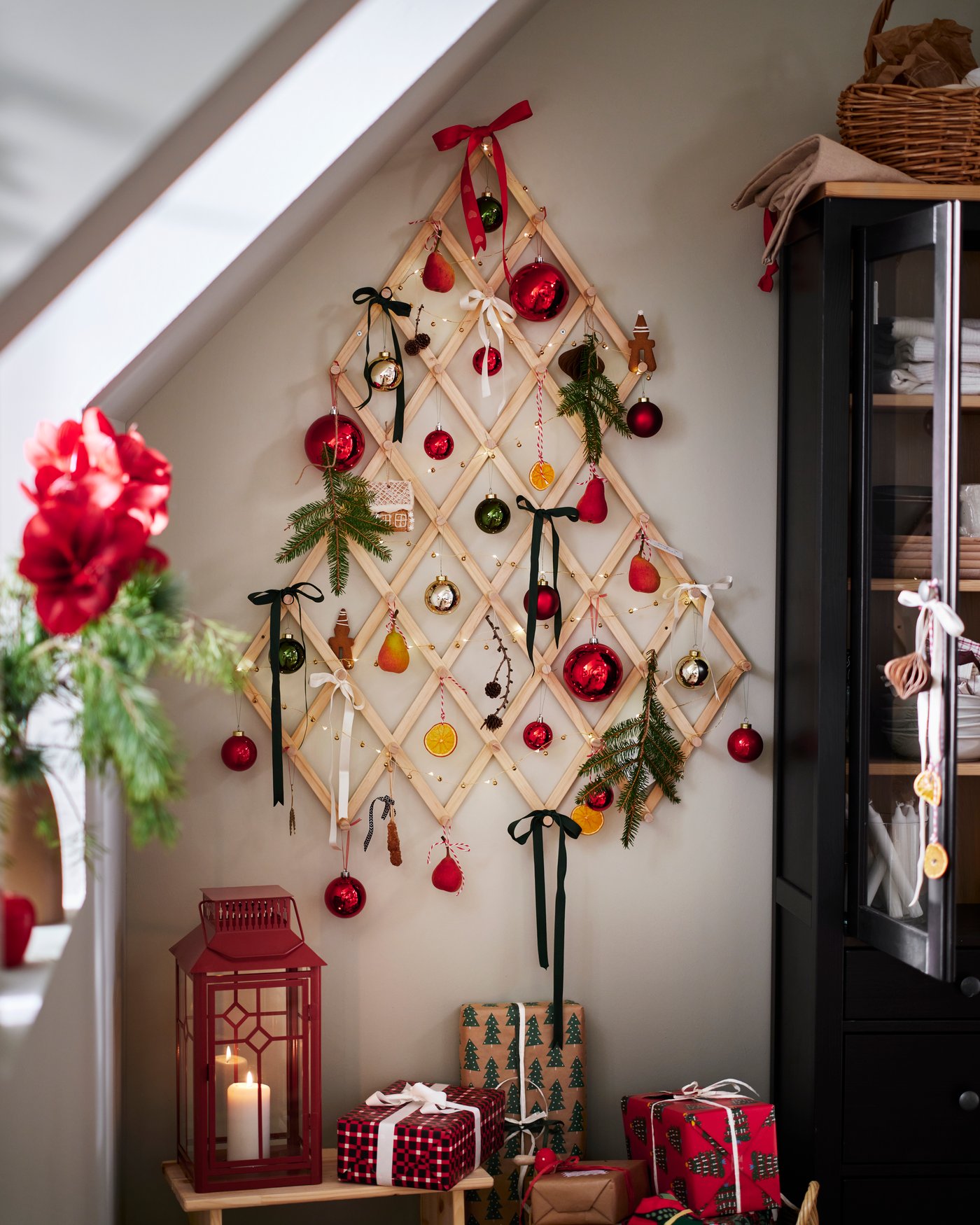 A wooden VINTERFINT decorative Christmas tree on the wall, adorned with festive ornaments.