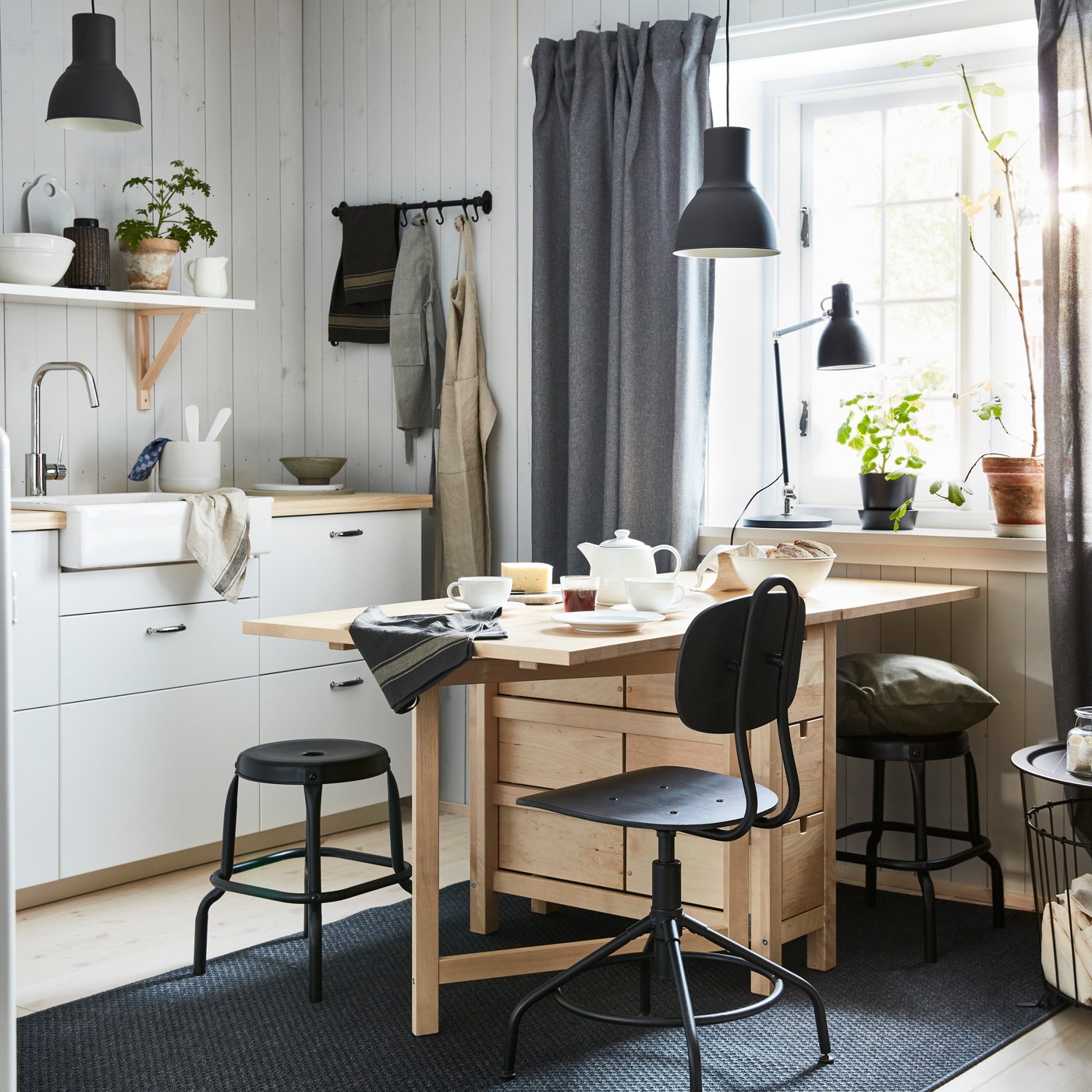 A black RÅSKOG stool in the home office
