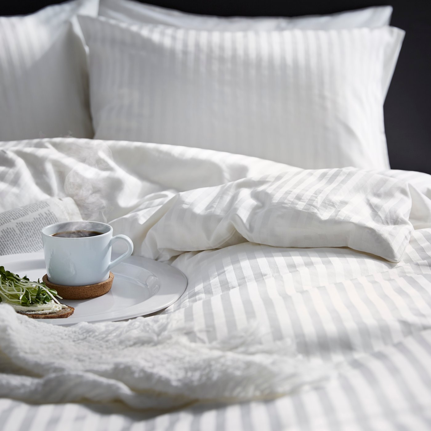 A firm/white ÅKREHAMN foam mattress in the bedroom