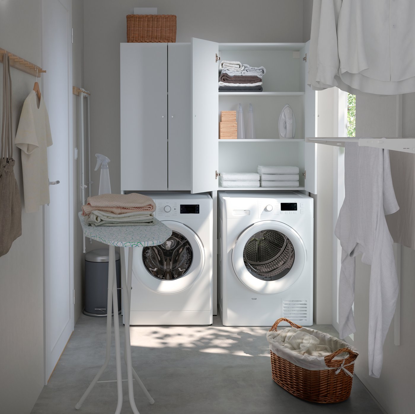 A white NYSJÖN cabinet for washing machine in the laundry room