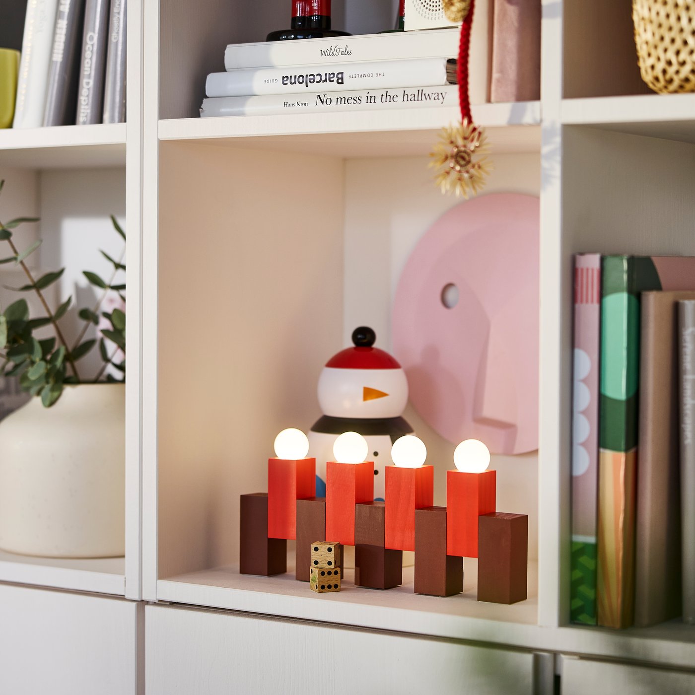 A battery-operated/wooden block red STRÅLA LED table decoration in the living room