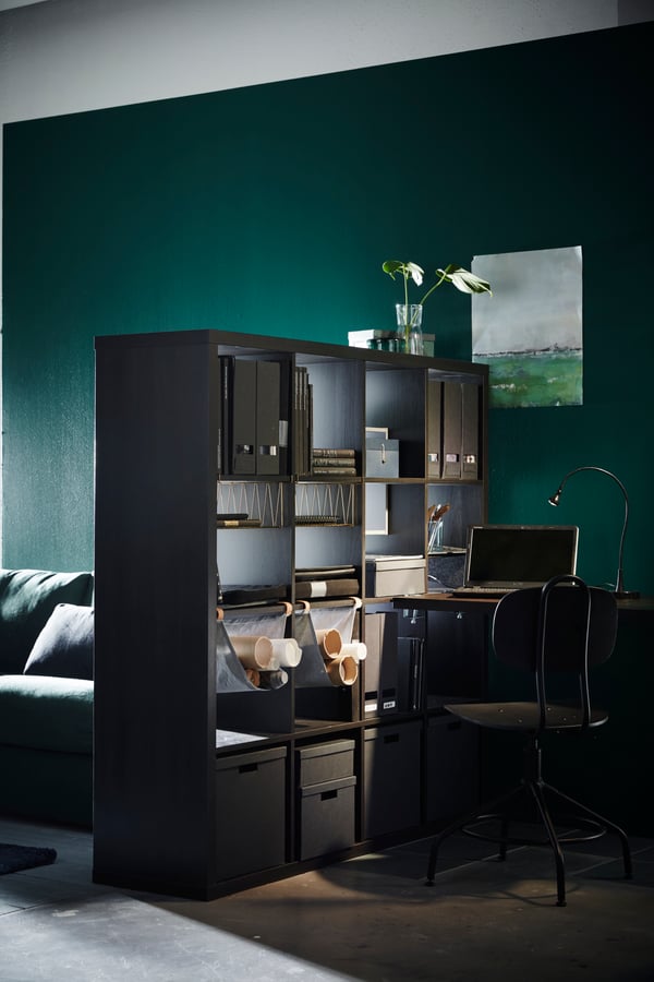 A black TJENA magazine file in the home office