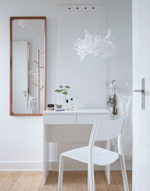 Small makeup corner in a white room.