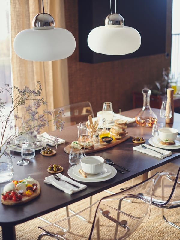 A chrome-plated/opal white glass DEJSA pendant lamp in the dining room