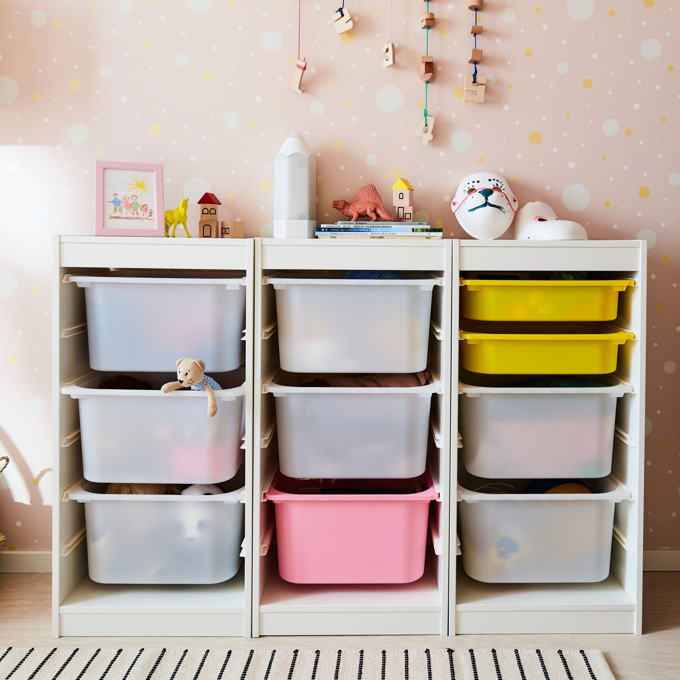 TROFAST children toy storage combination with a mixture of translucent, pink and yellow