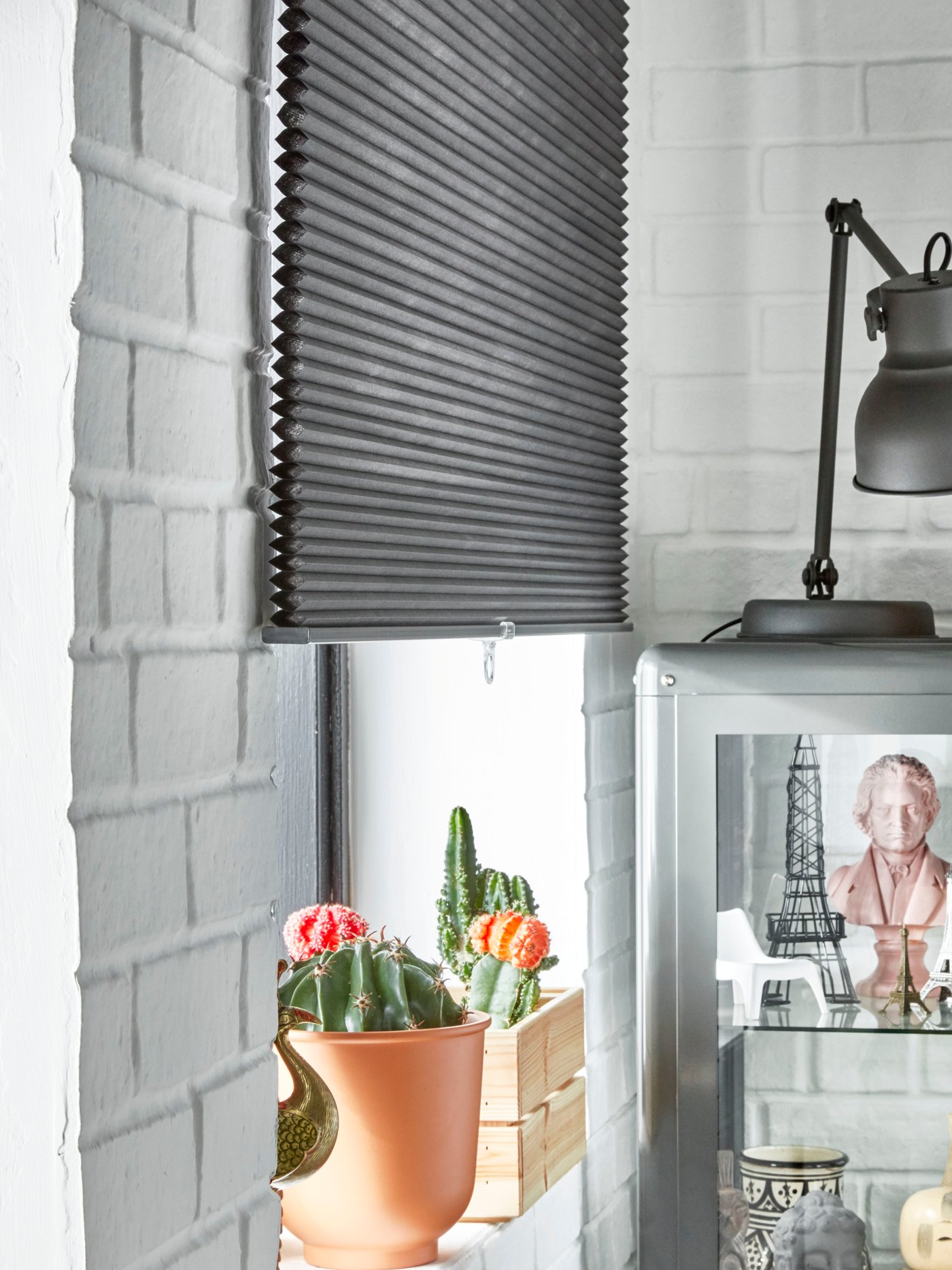 A dark grey FABRIKÖR glass-door cabinet