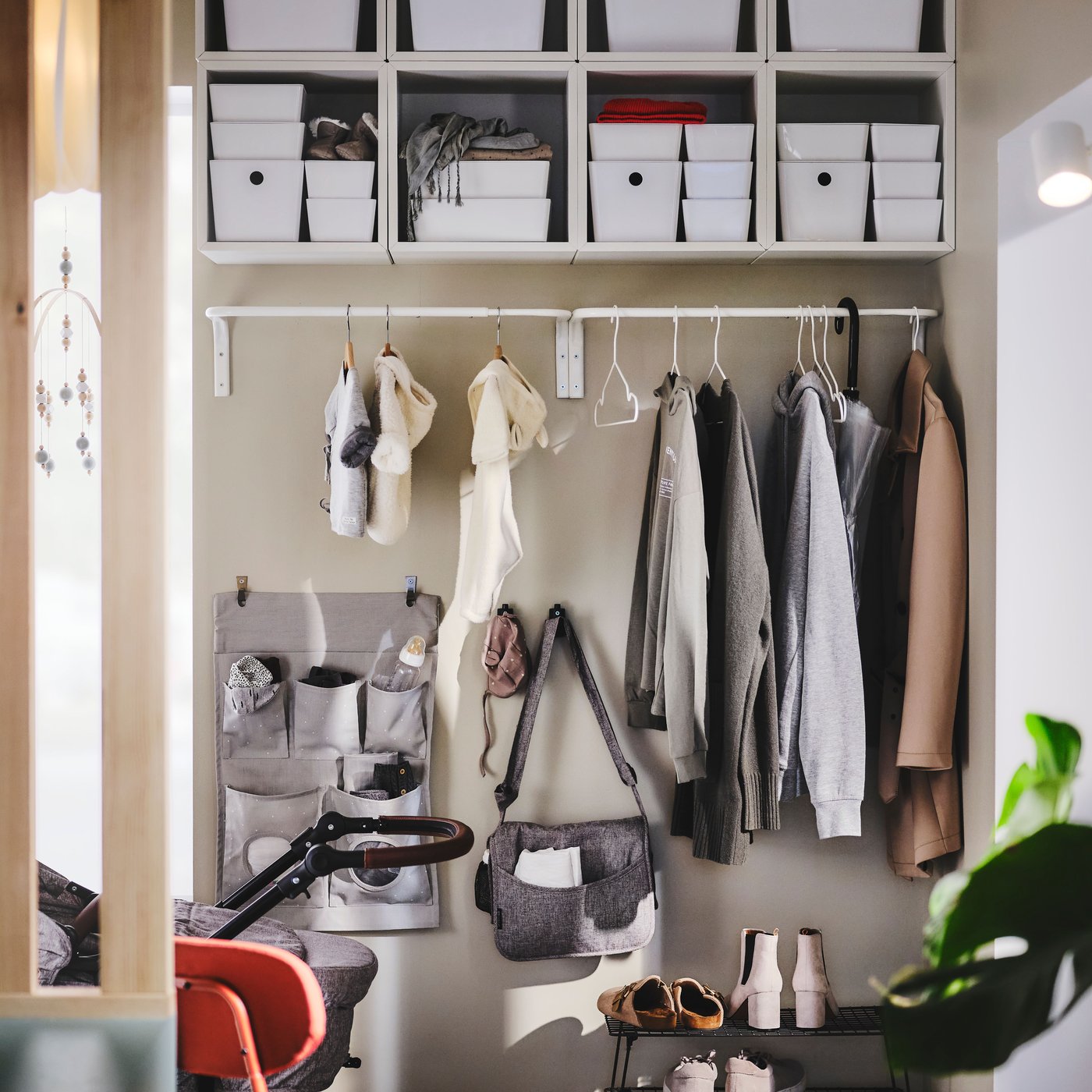 Organised entrance with wall storage, boxes, hooks, clothes and accessories.