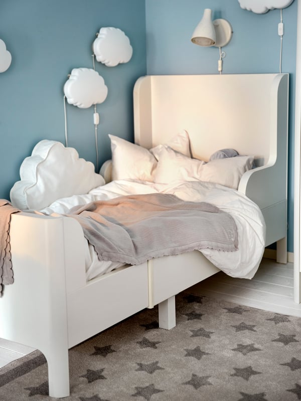 A white DRÖMSYN wall lamp in the childrens room