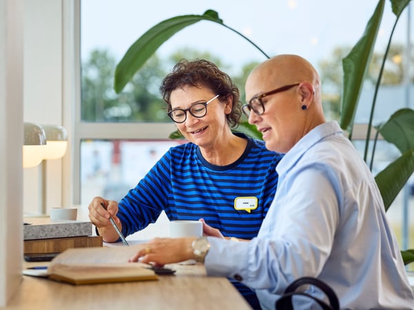 En IKEA-indretningsarkitekt hjælper en erhvervskunde med at planlægge et designprojekt.