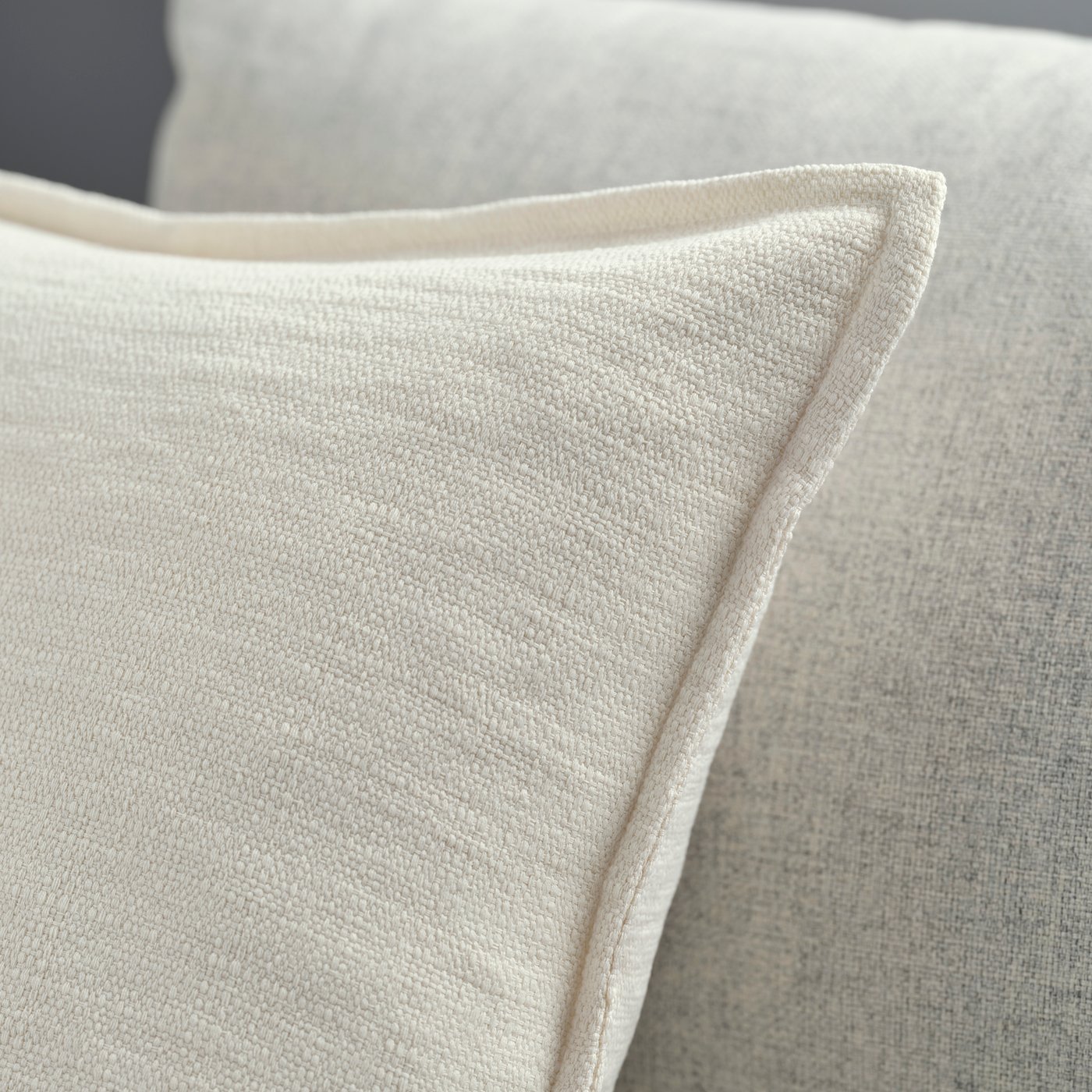 An off-white LAGERPOPPEL cushion cover
