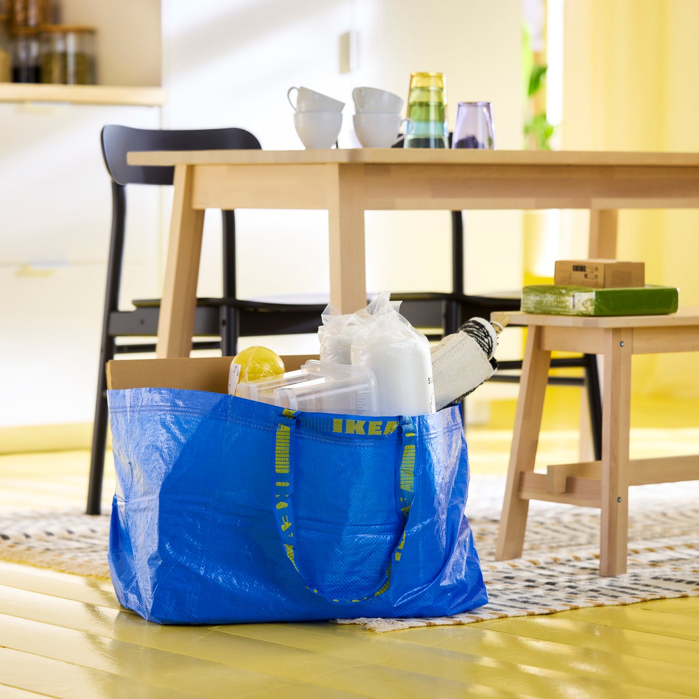 A blue FRAKTA carrier bag, large in the dining room