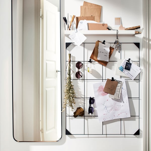 A black SÖSDALA memo board with clips in the hallway