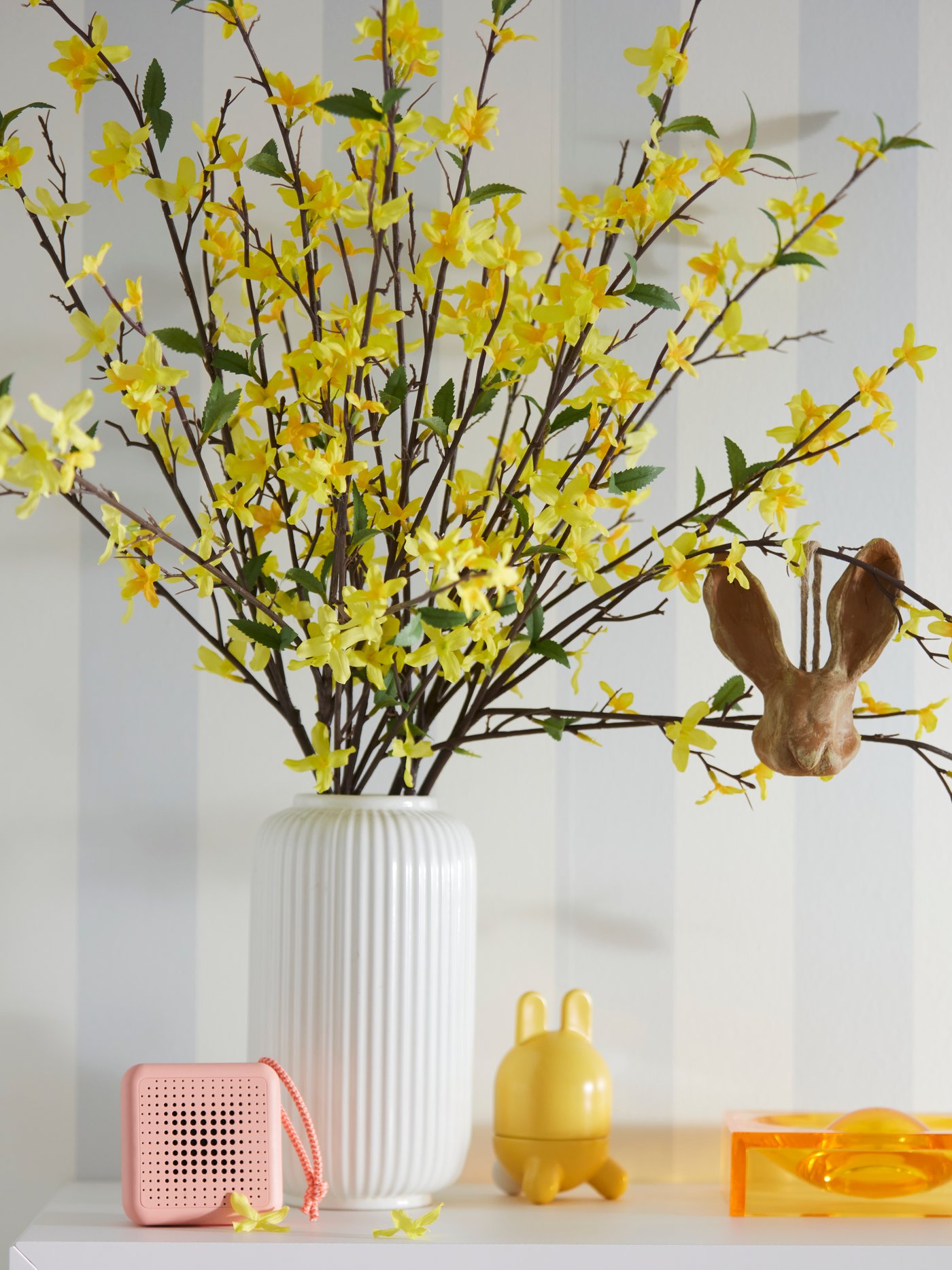 Yellow artificial SMYCKA flowers in a white vase.