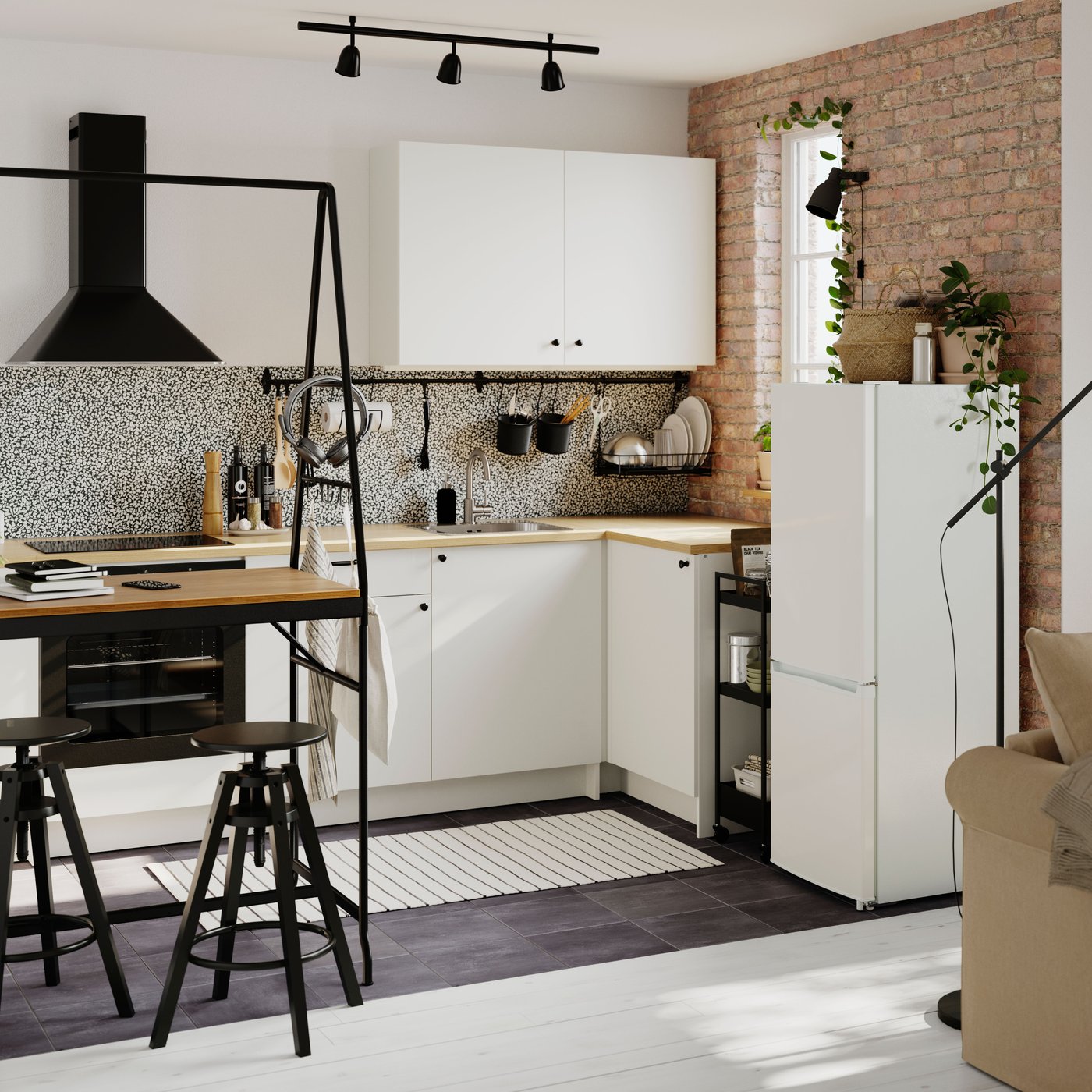 A small open-plan kitchen fitted with modules from the KNOXHULT series. A HÅVERUD table with storage ladder is on one side.