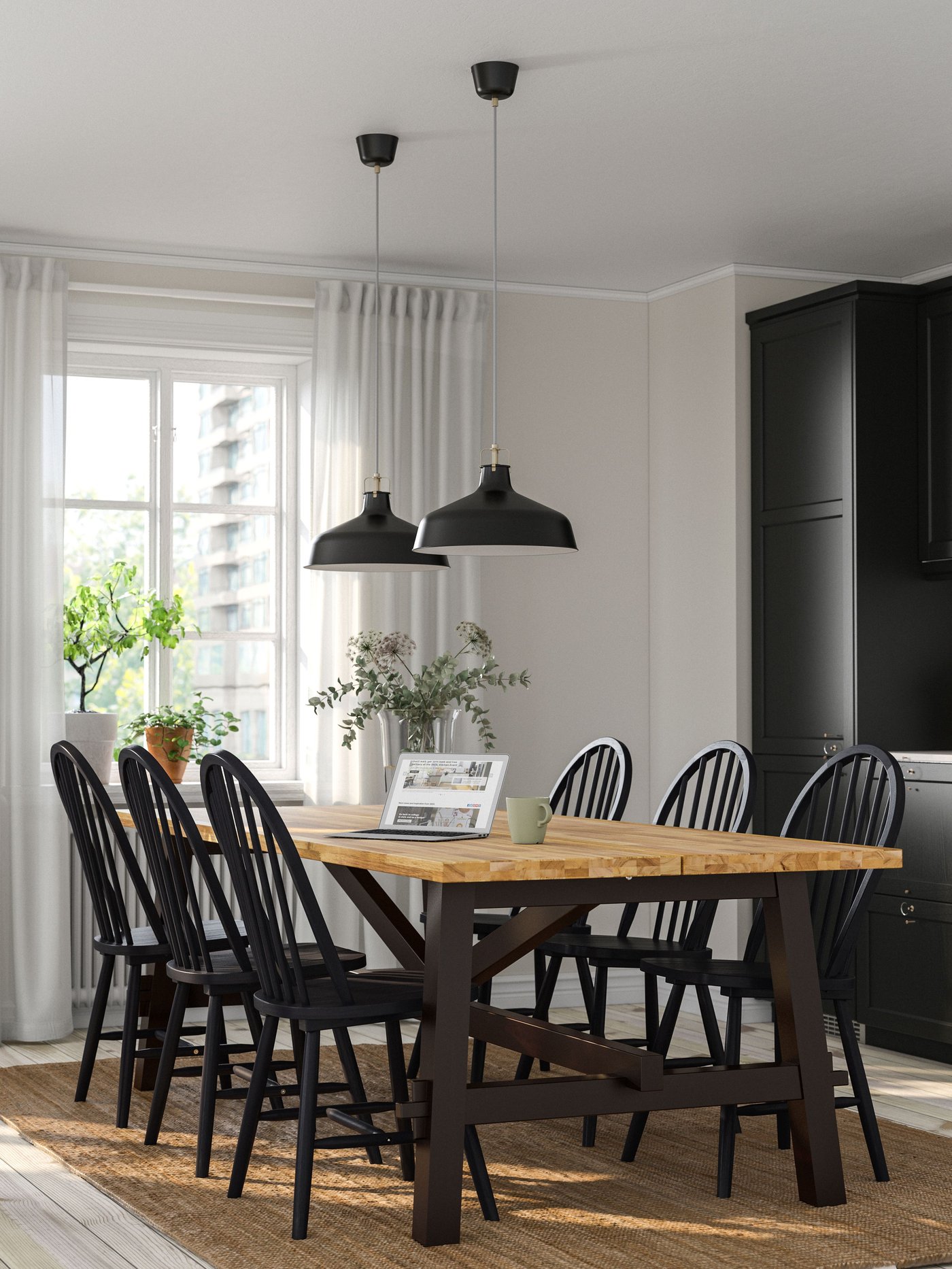 An acacia/black SKOGSTA dining table in the kitchen