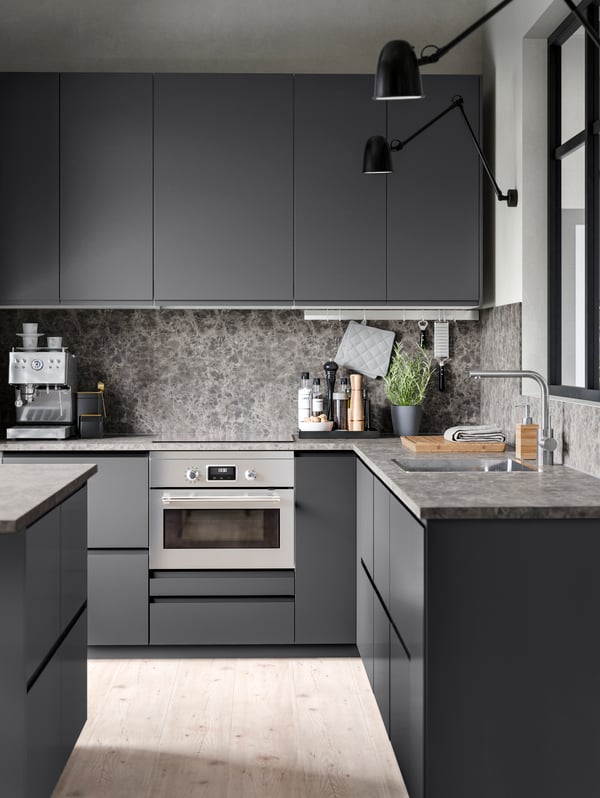 A microwave oven in a grey kitchen