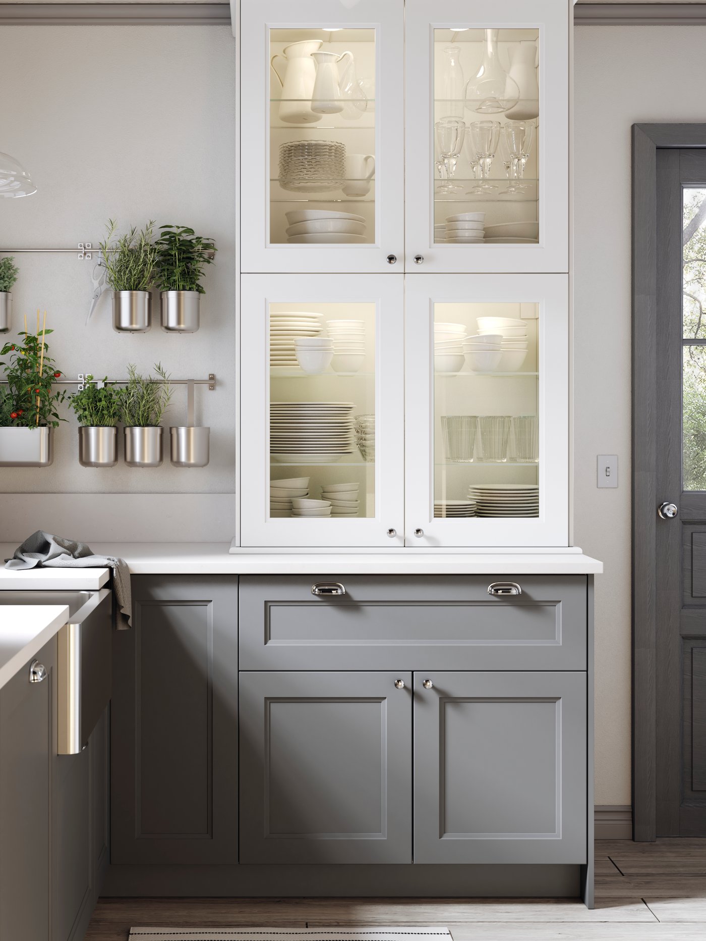 A bright kitchen featuring white and gray IKEA cabinets