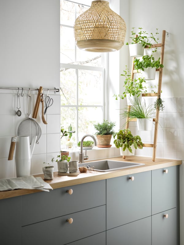 A bamboo/white SATSUMAS plant stand with 5 plant pots in the kitchen