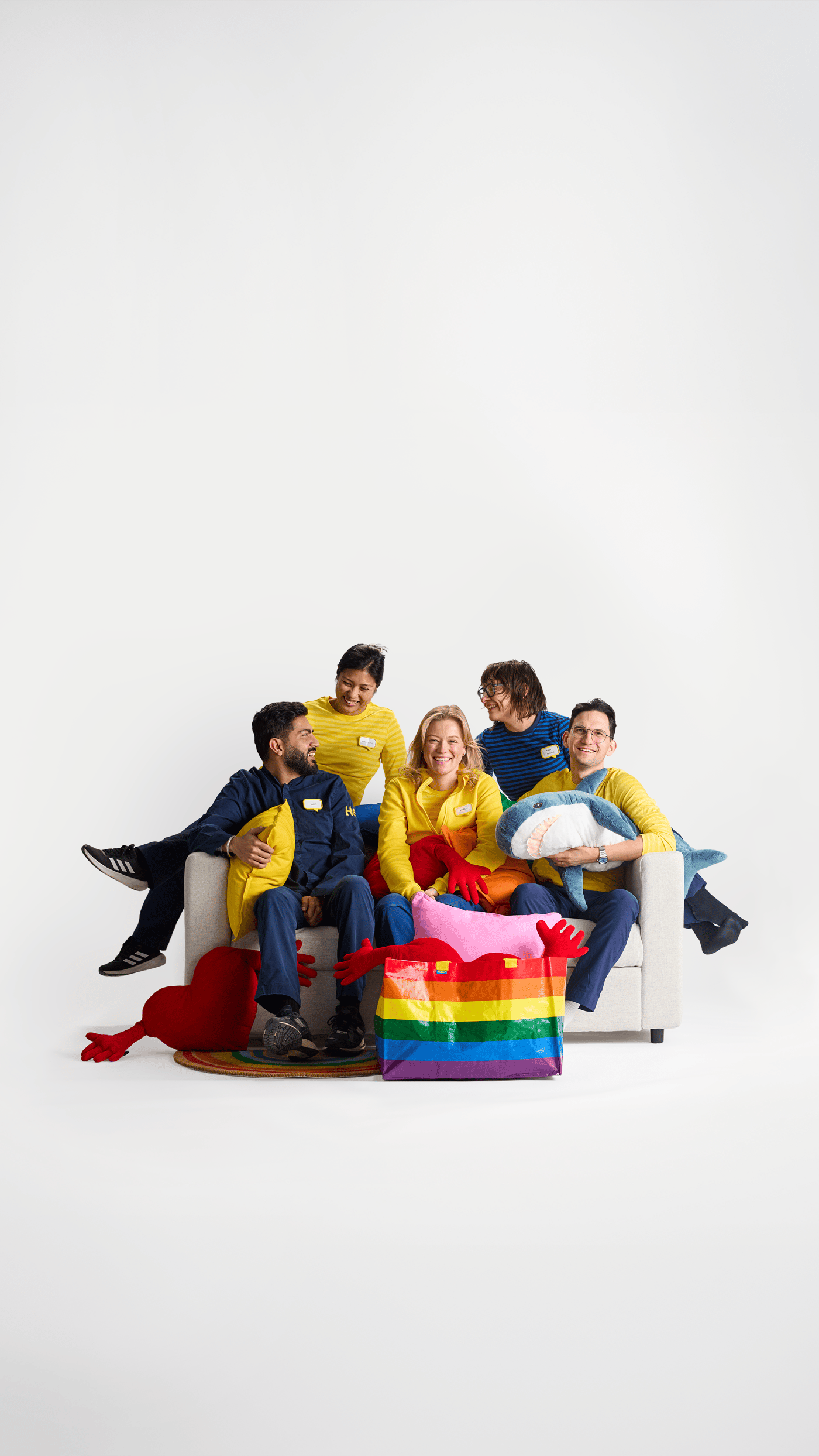 parta lidí s duhovou ikea taškou sedící na gauči