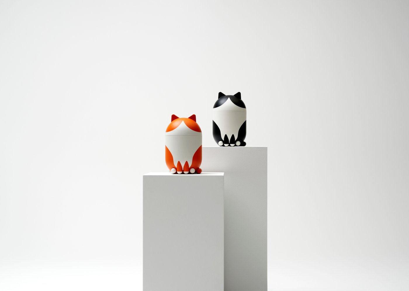 A cat-shaped orange/white GREJSIMOJS storage with lid
