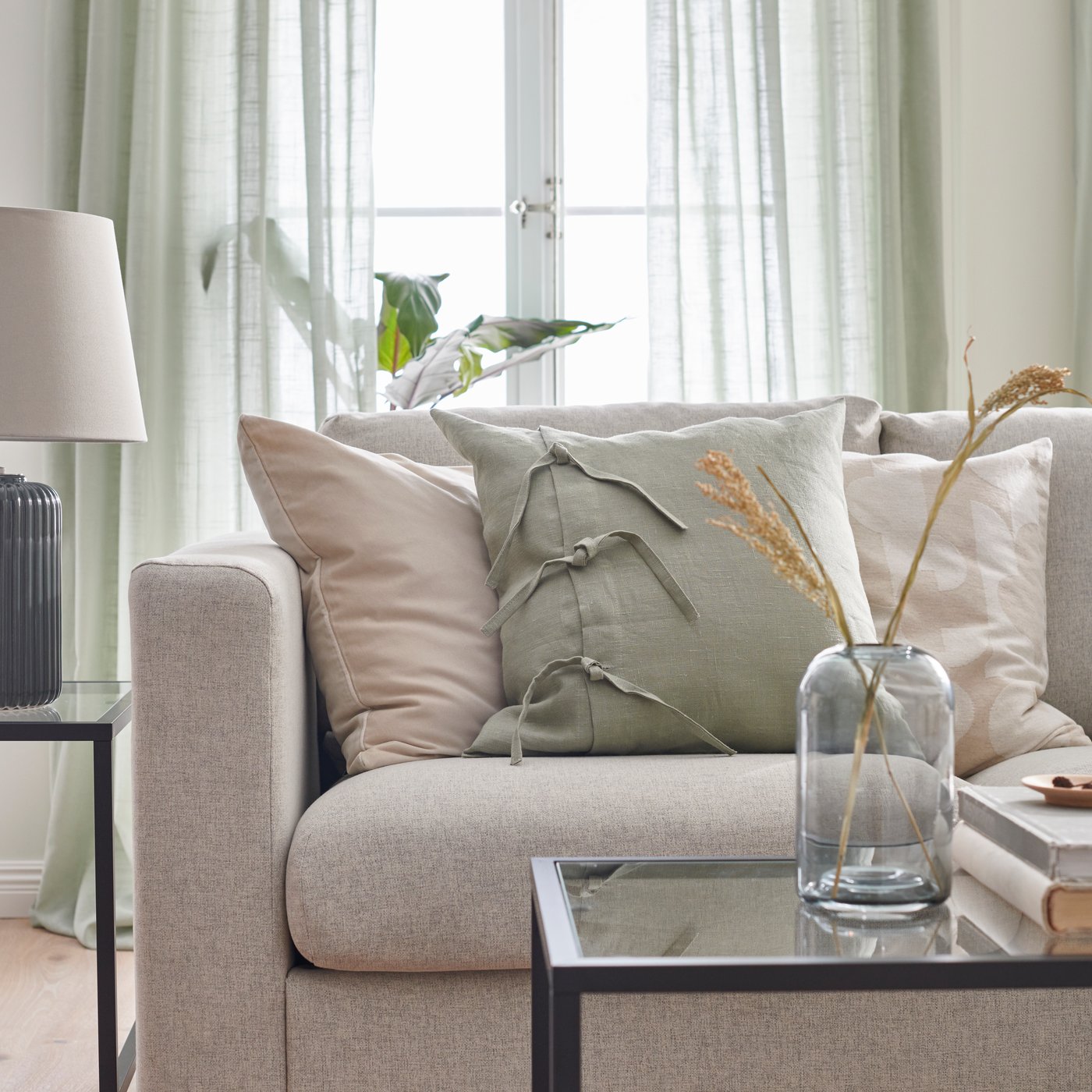 A light green AINA cushion cover in the living room