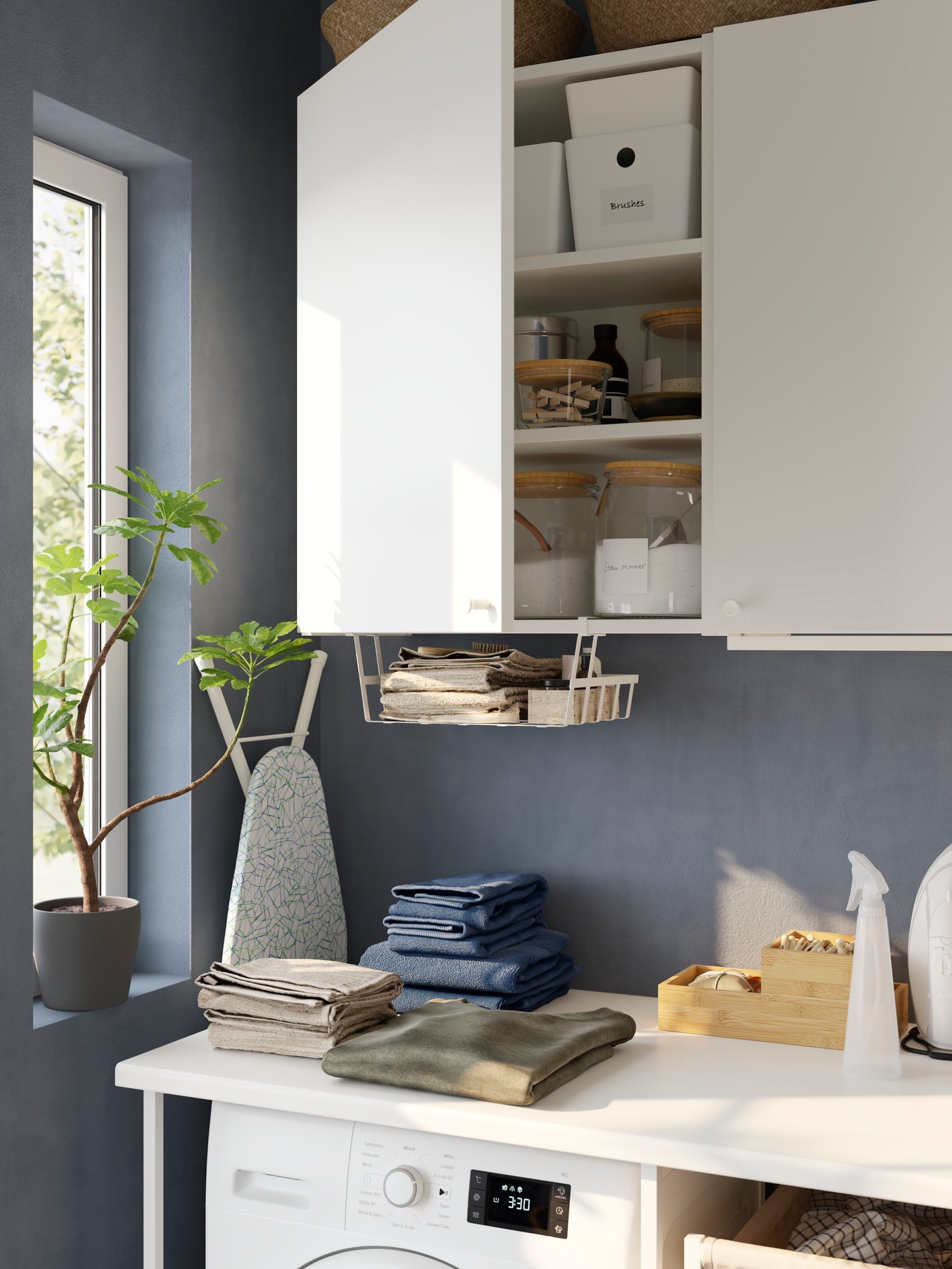 A white ENHET storage combination in the laundry room