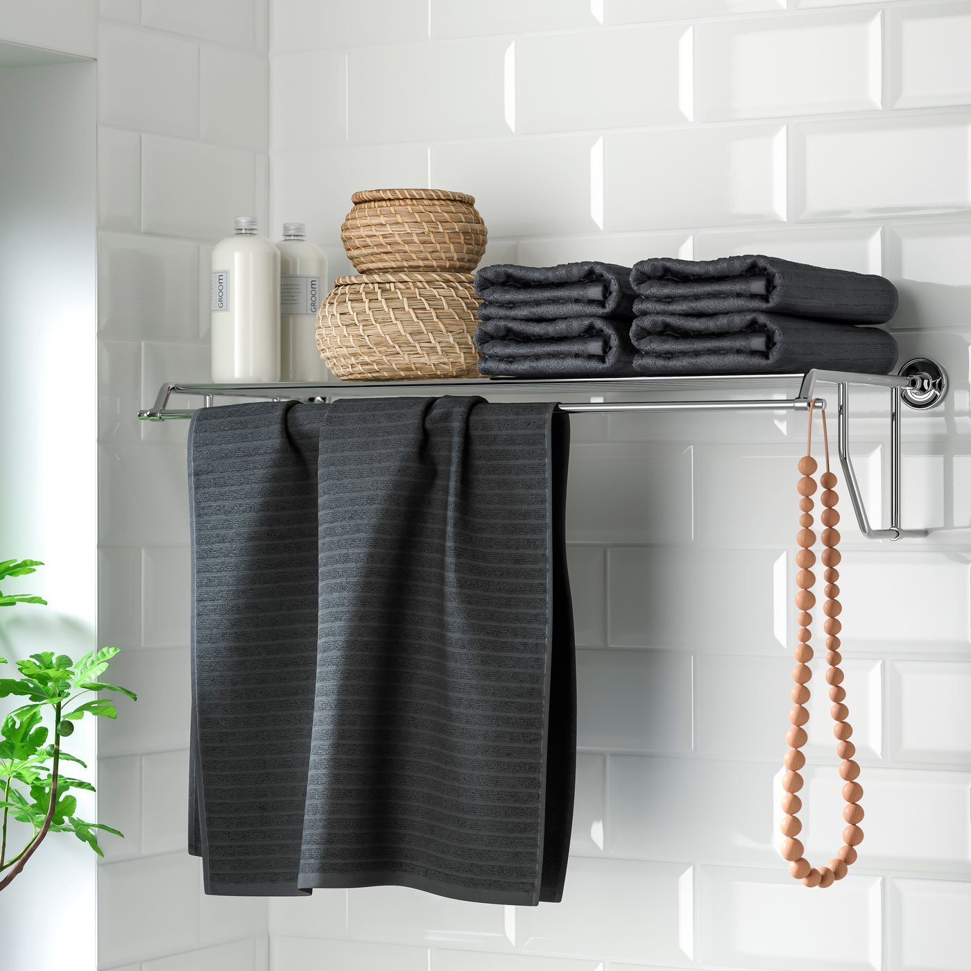 A chrome effect BROFJÄRDEN wall shelf with towel rail