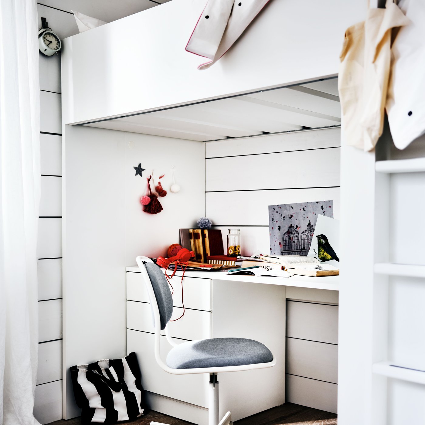 A white/Vissle light grey ÖRFJÄLL swivel chair in the childrens room