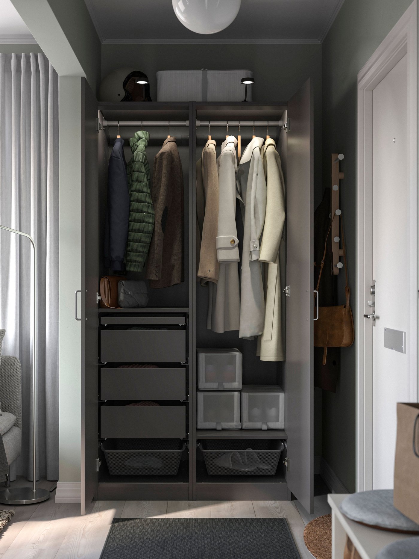 PAX grey wardrobe in bedroom with grey BERGSBO hinged doors, showing clothing hung neatly on BUMERANG hangers on top of drawers and SKUBB shoe boxes. 