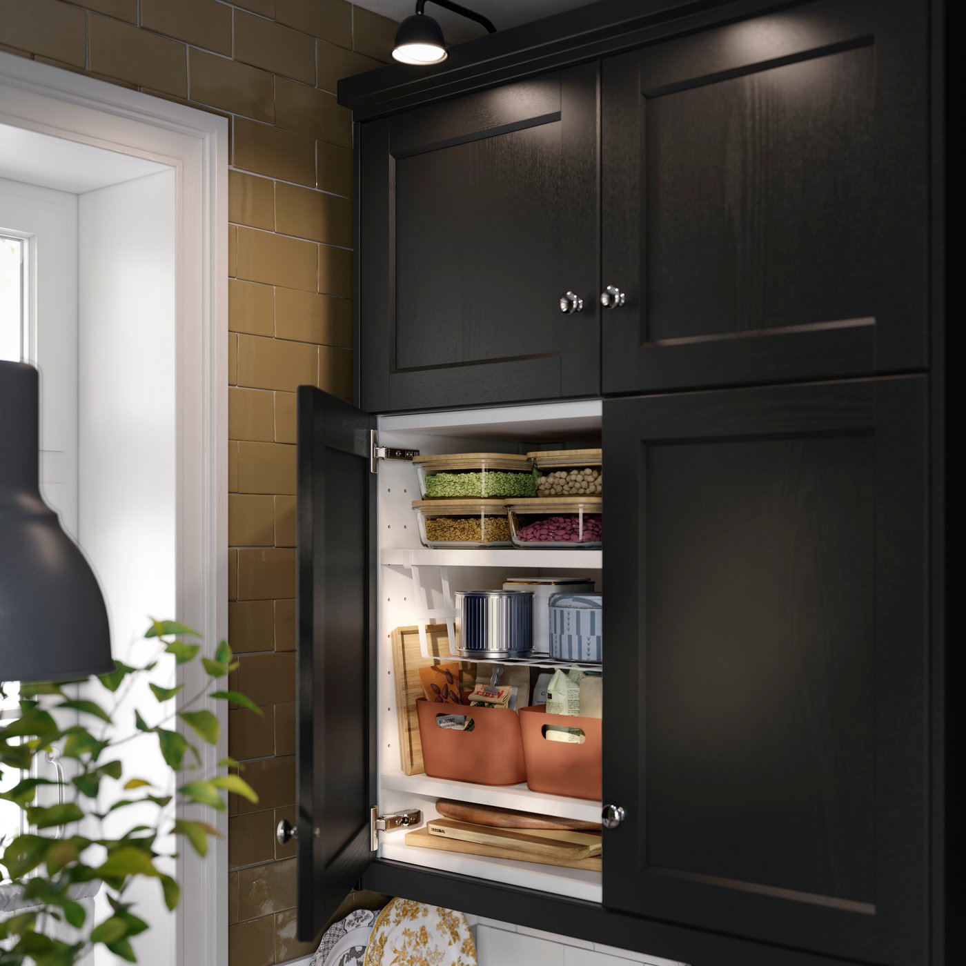 Inside a kitchen abinet featuring white PÅLYCKE clip-on basket attached to a shelf holding organised containers & items.