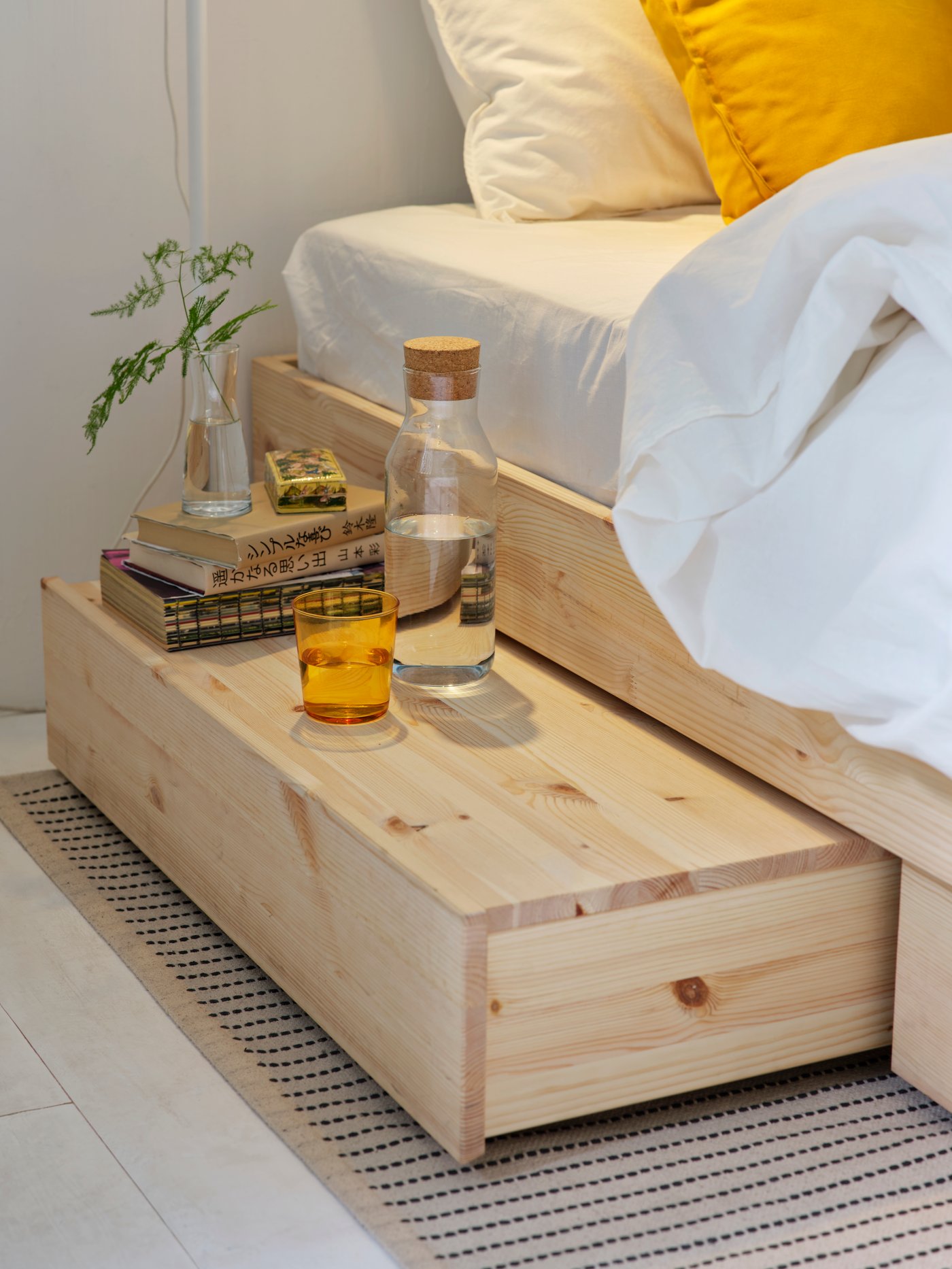 A pine GLAMBERGET extendable bed with storage in the bedroom
