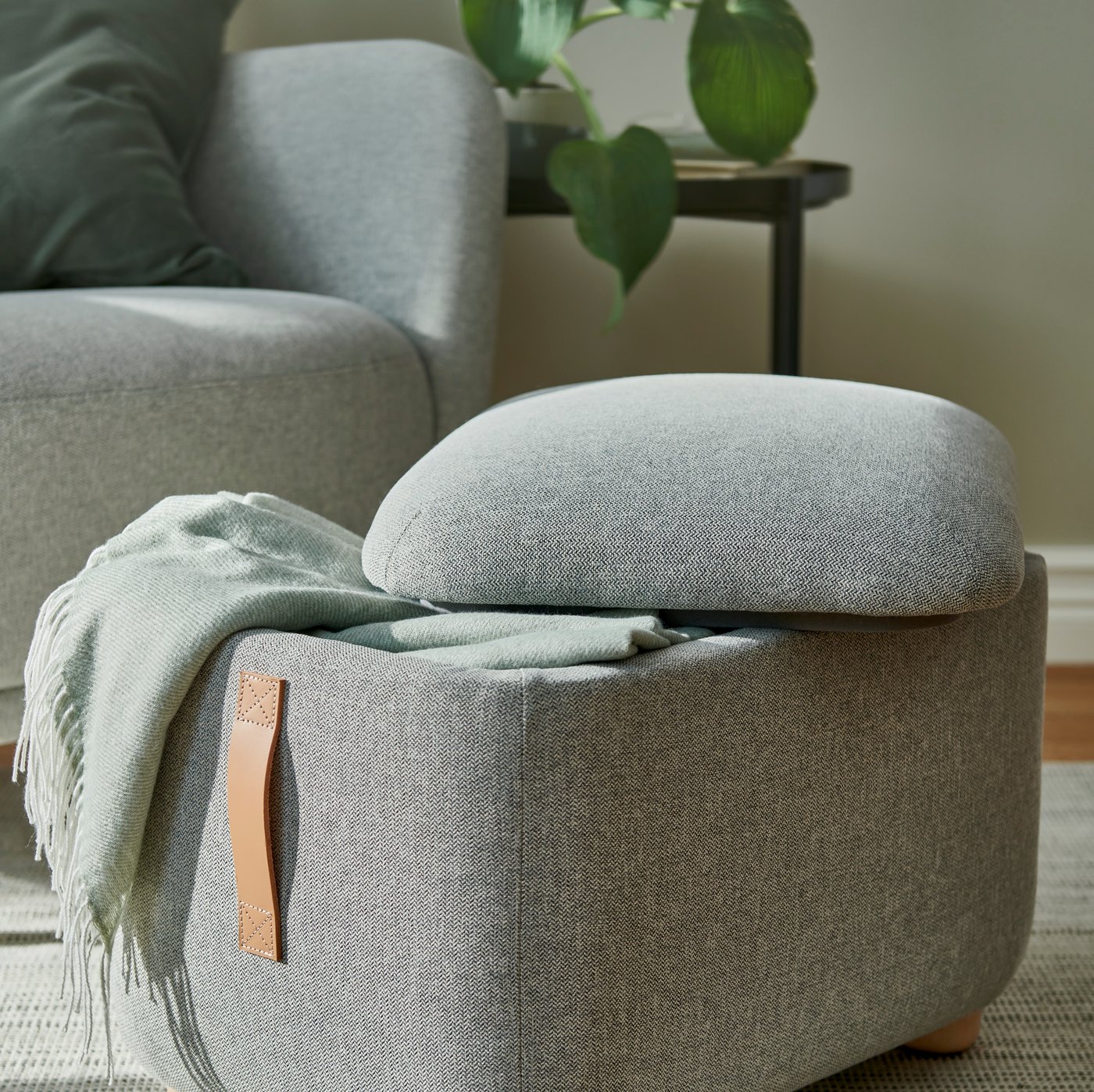 A light grey-green HOLMVI throw
