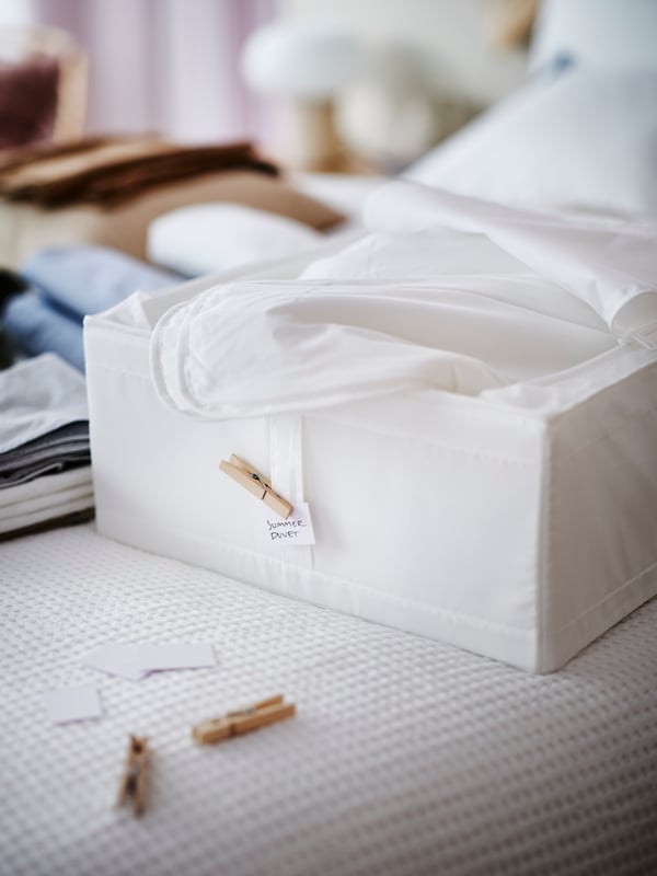 A white SKUBB storage case in the bedroom