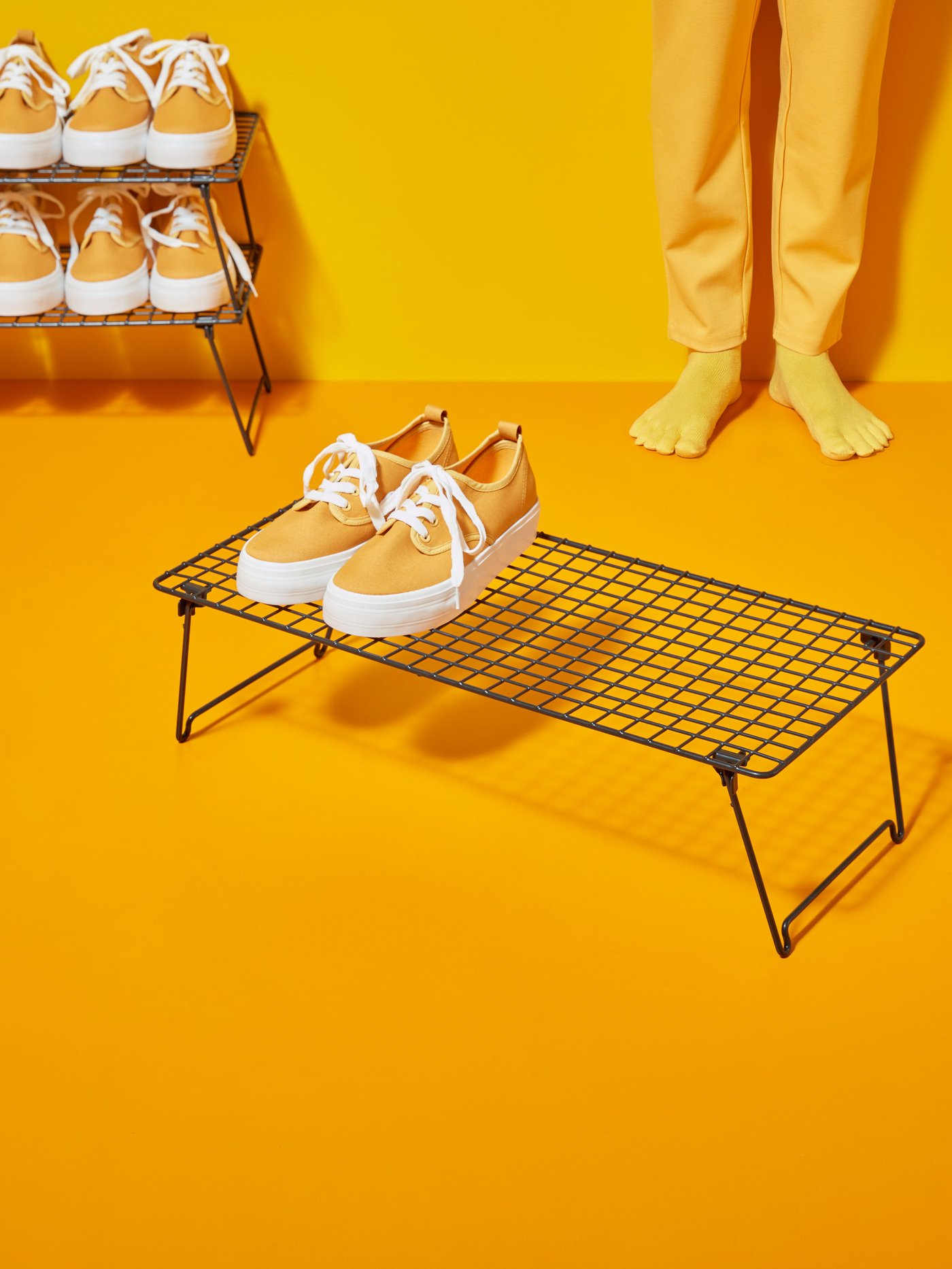 A grey GREJIG shoe rack in the hallway