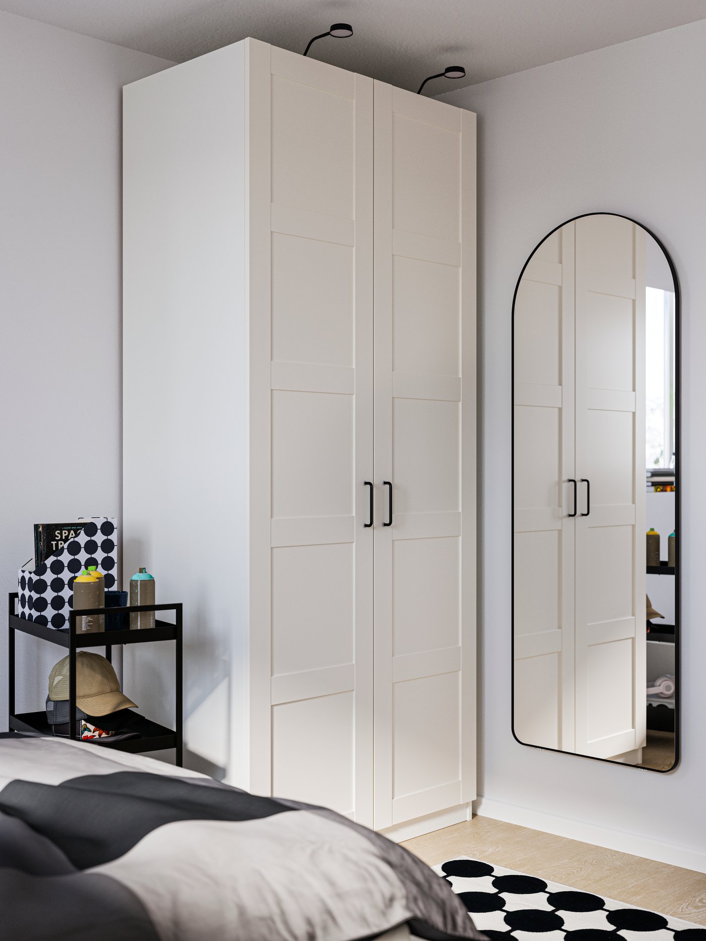 A white PAX wardrobe in the corner of a room, with a LINDBYN mirror on the wall to the right and a bed in the foreground.