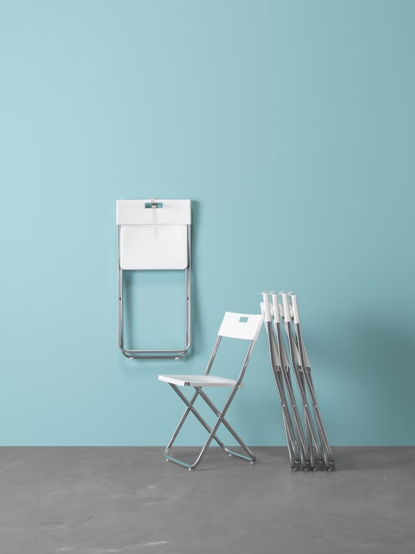 A white GUNDE folding stool