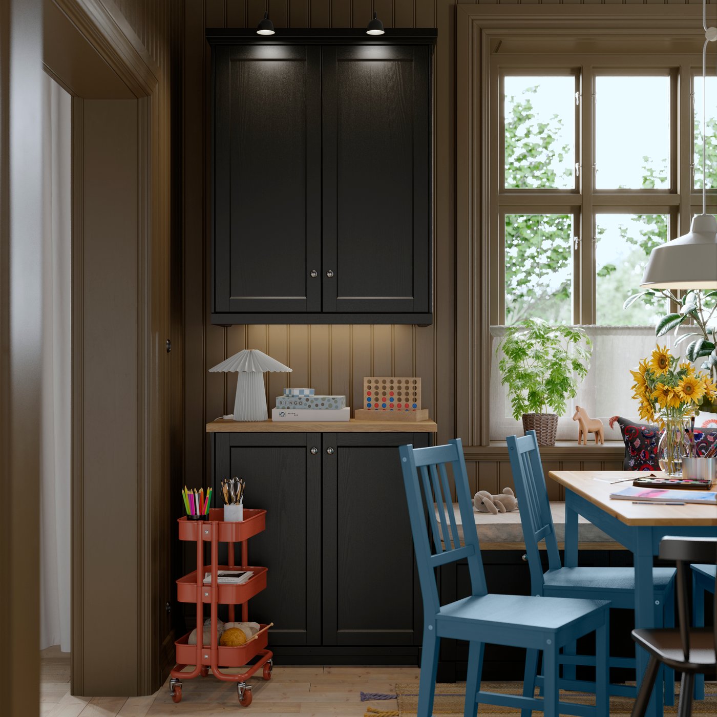 A kitchen area featuring METOD cabinets with two black-grey LERHYTTAN doors, placed next to a trolley and dining chairs.