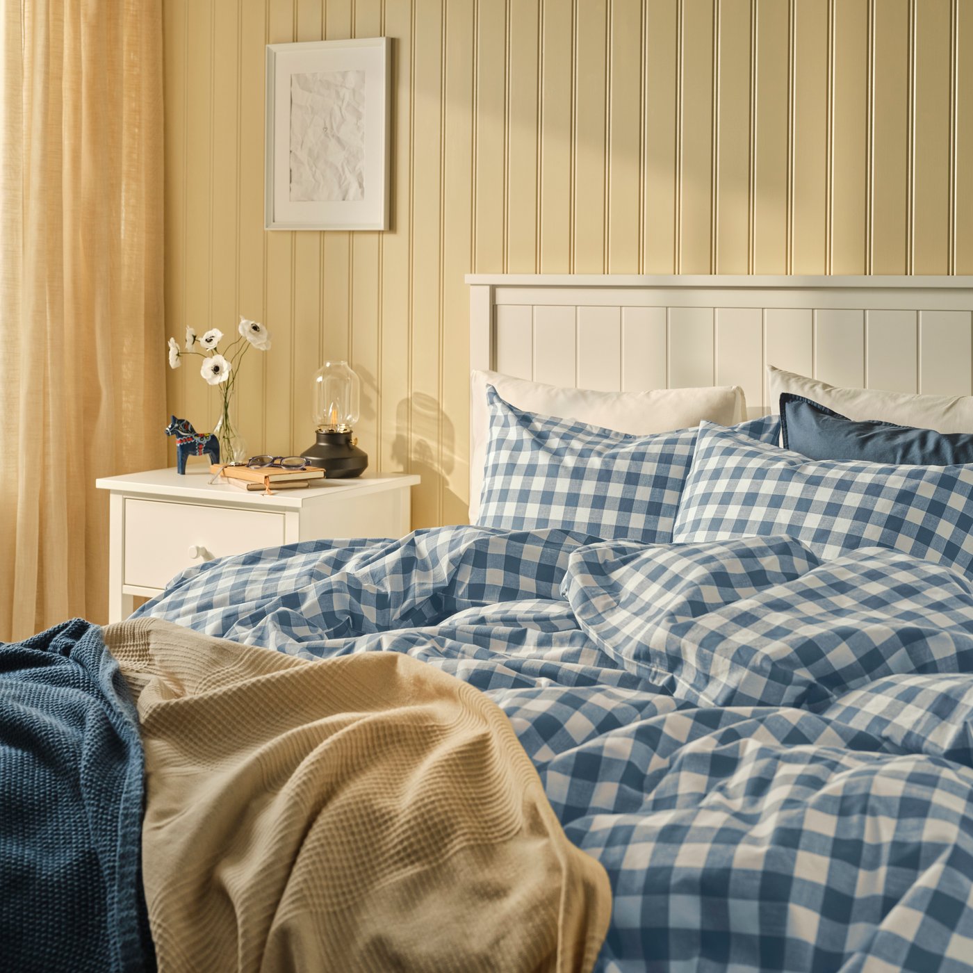 A dark blue white/check EKTANDVINGE duvet cover and pillowcase
