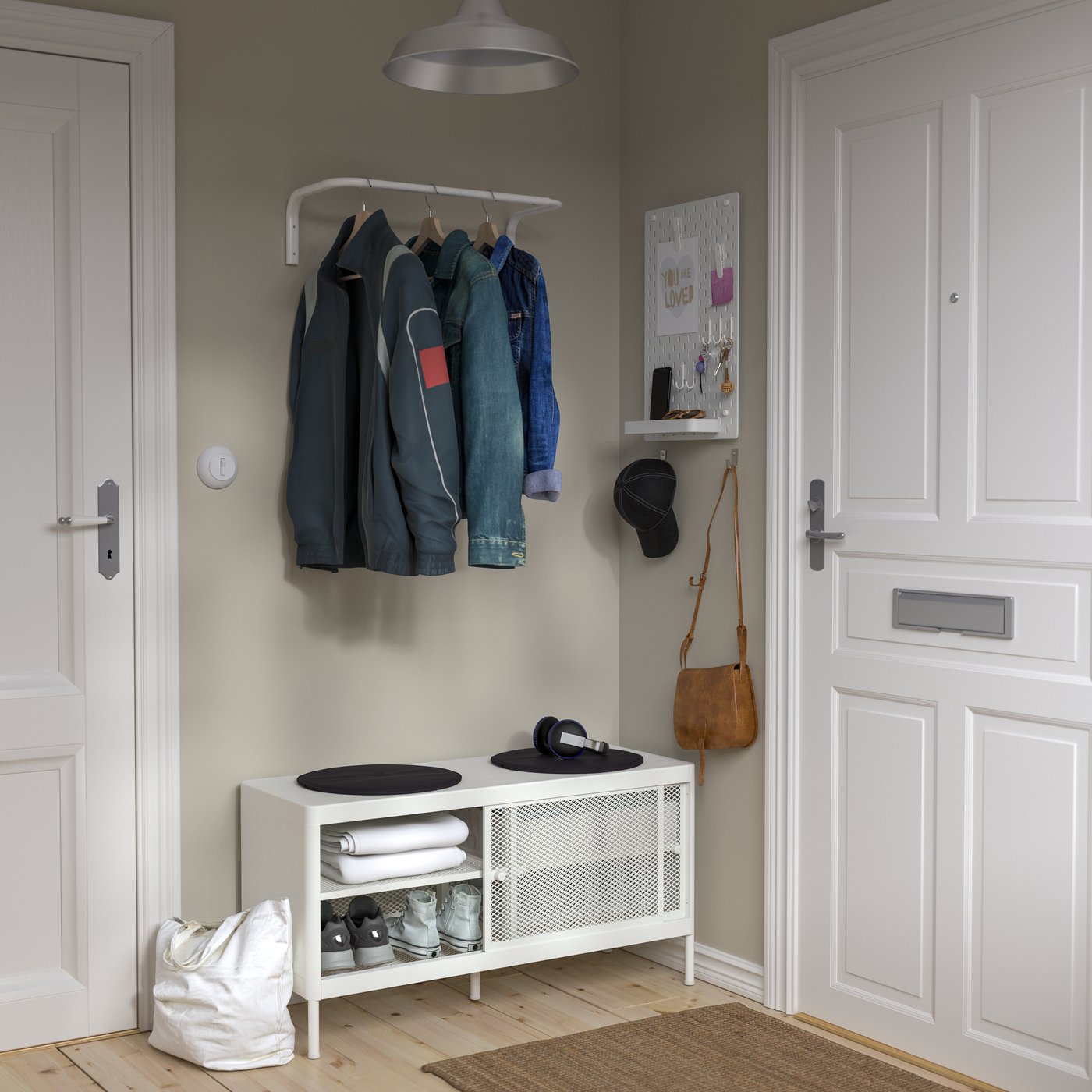 A white MACKAPÄR storage bench with sliding doors in the hallway