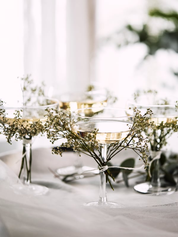 STORHET champagne glasses decorated with flowers.