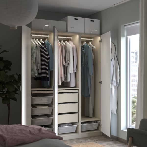 PAX wardrobe with integrated lighting on the inside and outside, a neatly organised white wardrobe.